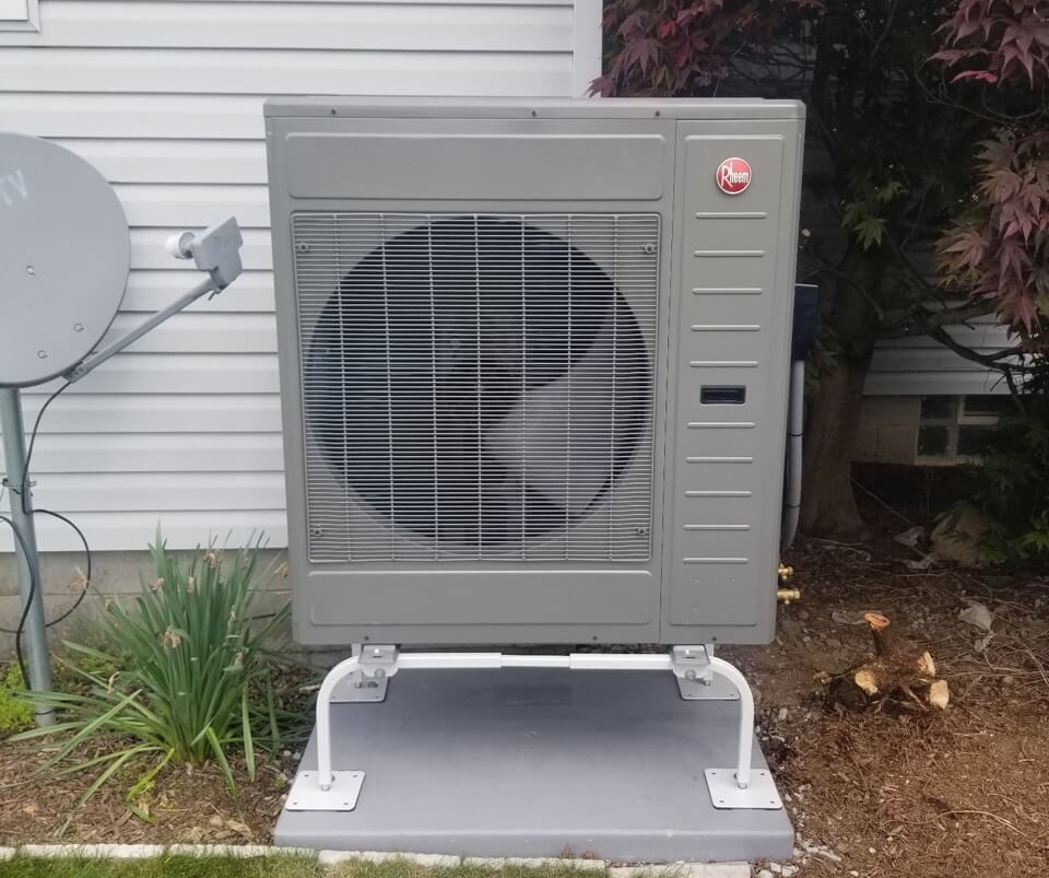 Heat pump outside of home in backyard