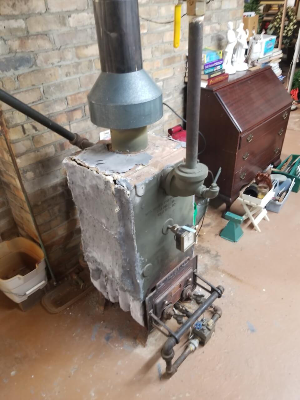 Old, rusted out boiler in basement